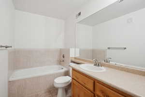 Full bathroom with a garden tub, vanity, and tile patterned floors