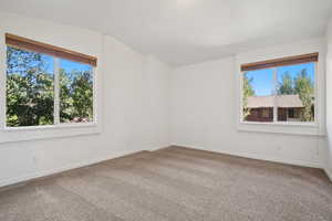 Unfurnished room with carpet flooring and baseboards