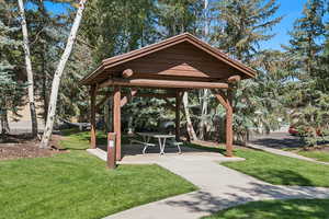 View of community with a patio area, a yard, and a gazebo