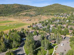Aerial view of property's location featuring nearby suburban area and a mountainous background