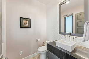 Half bath featuring vanity and wood finished floors