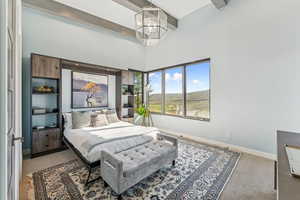 Bedroom featuring carpet flooring, beam ceiling, a high ceiling, and a chandelier