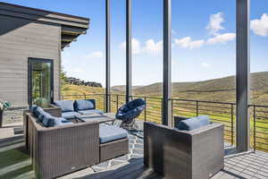 Wooden deck with outdoor lounge area and a mountain view