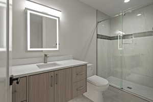 Bathroom featuring vanity, a shower stall, and light tile patterned floors
