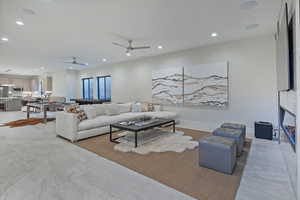 Living room featuring recessed lighting and a ceiling fan