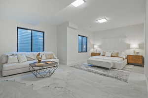 Bedroom with marble finish flooring and baseboards