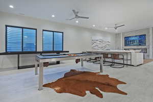 Rec room with ceiling fan, recessed lighting, and a fireplace