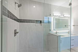 Bathroom with a shower stall and vanity