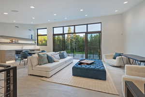 Living area with recessed lighting, wine cooler, and bar with sink