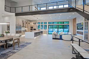 Dining space with a high ceiling and recessed lighting