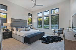 Bedroom featuring a towering ceiling, a ceiling fan, and wood finished floors