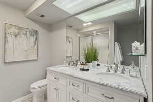 Full bathroom with a stall shower and double vanity