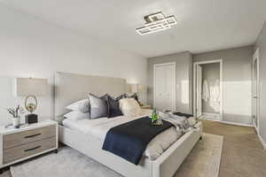 Bedroom with light carpet, a closet, and ensuite bath