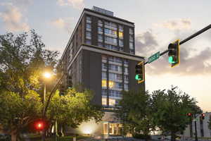 Property at dusk with a view of apartment building / complex