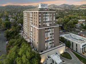 Property at dusk featuring a view of apartment building / complex and a mountain view