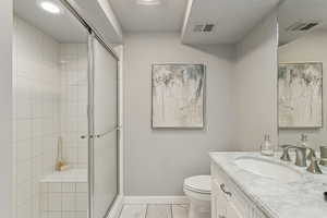 Bathroom featuring vanity and a shower stall