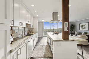 Kitchen featuring white cabinetry, a kitchen breakfast bar, recessed lighting, backsplash, and dark wood finished floors