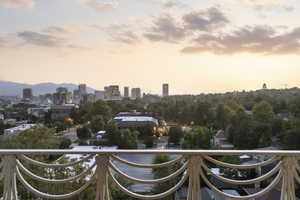 Balcony at dusk featuring a city view