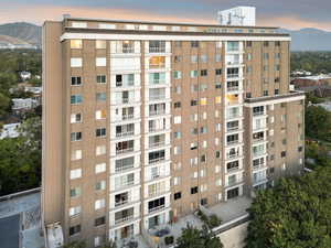 Property at dusk featuring a mountain view and a view of apartment building / complex