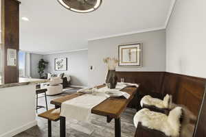 Dining area featuring crown molding, wood finished floors, and recessed lighting