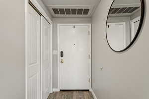 Doorway to outside featuring wood finished floors and baseboards