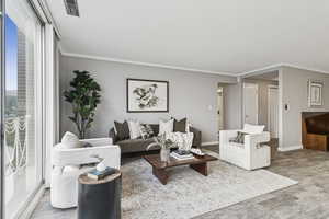 Living area featuring ornamental molding and wood finished floors