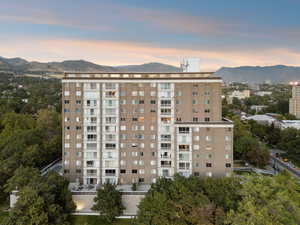 Property at dusk with a view of apartment building / complex and a mountain view