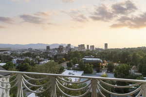 Balcony at dusk featuring a city view