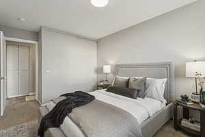 Carpeted bedroom featuring a closet