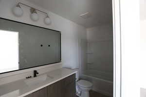 Bathroom featuring vanity and shower / washtub combination