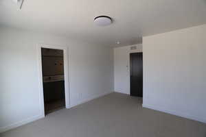 Unfurnished bedroom featuring carpet floors and baseboards