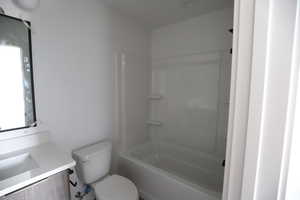 Bathroom with vanity and shower / washtub combination