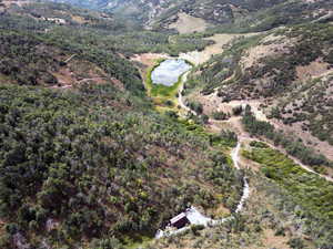 Aerial view of property and surrounding area with a nearby body of water