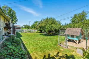 Fenced backyard featuring exterior structure and an outdoor structure
