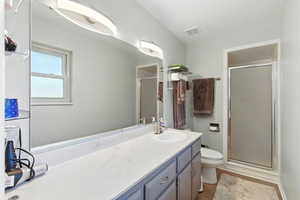Bathroom featuring a stall shower and vanity