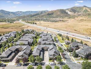 Aerial overview of property's location featuring mountains and nearby suburban area