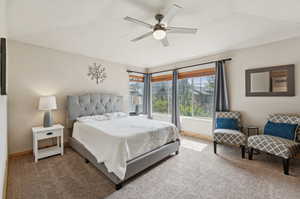 Carpeted bedroom with baseboards and ceiling fan
