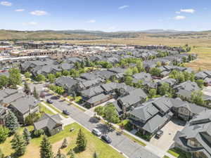 Aerial overview of property's location featuring a mountainous background and nearby suburban area