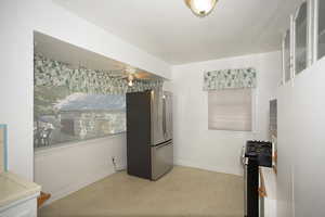 Kitchen with stainless steel appliances and glass insert cabinets