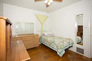 Bedroom with dark wood-type flooring and a ceiling fan