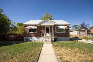 Bungalow featuring brick siding and a porch