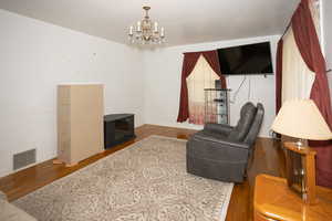 Living room with a chandelier and wood finished floors