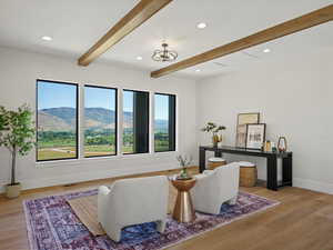 Sitting room featuring a mountain view, beam ceiling, recessed lighting, and light wood finished floors