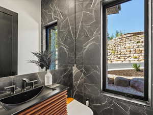 Half bathroom with plenty of natural light and vanity