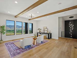 Living room with recessed lighting, beamed ceiling, a mountain view, and light wood finished floors