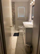 Bathroom with double vanity and bathing tub / shower combination