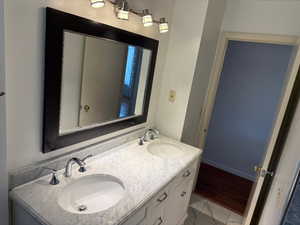 Full bath featuring double vanity