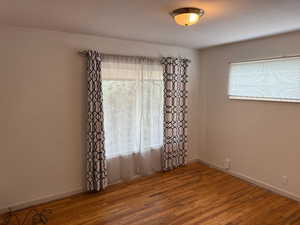 Spare room featuring plenty of natural light and wood finished floors