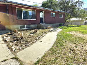 Single story home with brick siding and a front lawn