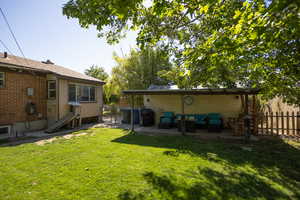 Rear view of house with an outdoor living space and a patio area